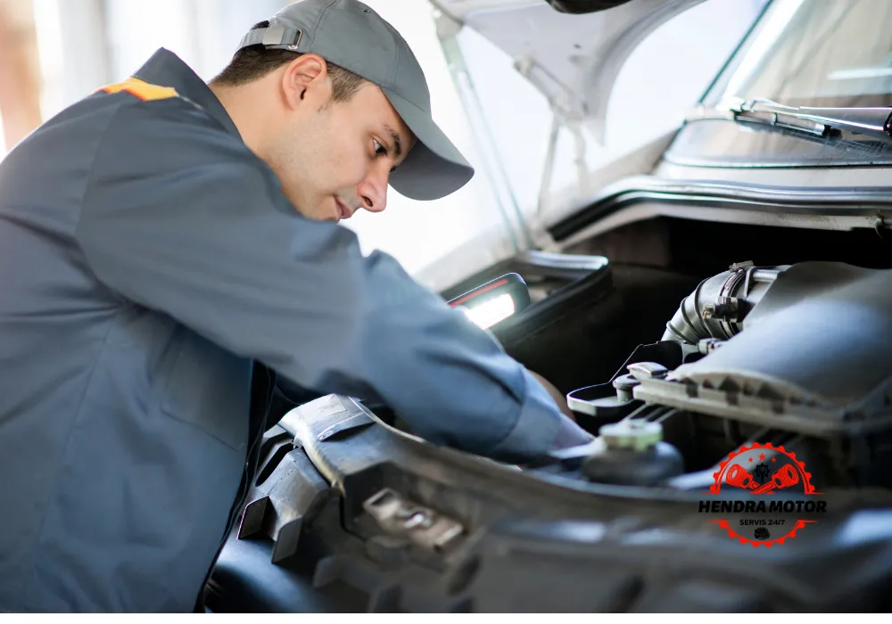 Jasa bengkel panggilan murah sedang melakukan jumper aki kendaraan.